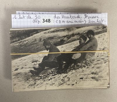 an old photo of a man and a woman on a snowboard
