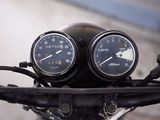 two speedometers on the handlebars of a motorcycle