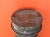 a rusted metal object on an orange background