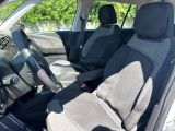 the interior of a car with two rows of seats and a steering wheel