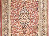 a red and black rug with a medallion design on it