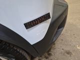 a close up of a sticker on a car ' s bumper
