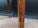 a close up of a wooden table on a carpeted floor