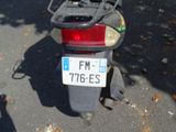 a motorcycle with a license plate on it parked on the street