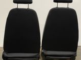 a pair of black leather seat covers on a pallet
