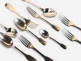 several spoons, forks and spoons are lined up on a white surface