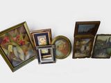 many framed pictures and paintings on the wall