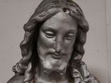 a statue of jesus holding a baby in his arms