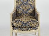 a blue and gold upholstered chair with a wooden frame