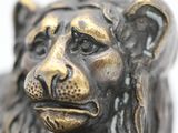 a close up of a statue of a lion on a white background