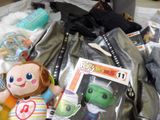 a pile of toys and other items on a bed