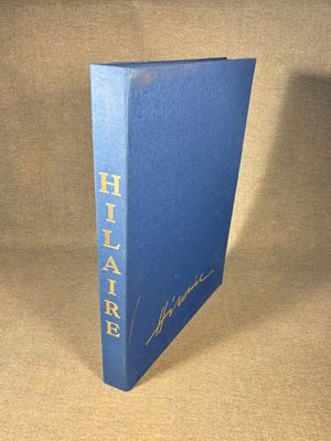 a blue book with gold lettering on it sitting on a table