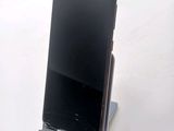 a cell phone that is on a stand on a table