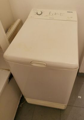 a white washer and dryer in a small room