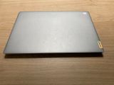 an open laptop computer sitting on top of a wooden table