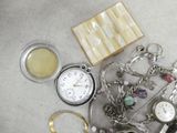 a lot of jewelry that is laying out on the table