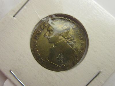 une vieille pièce de monnaie sur laquelle figure l'image d'un homme