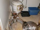 an old mixer sitting in the corner of a room