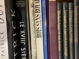 many books that are on a shelf in the room