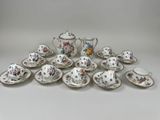 many different types of tea cups and saucers on the table