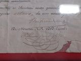 a piece of paper with writing on it on a red surface