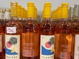 several bottles of wine are lined up on a counter