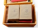 a wooden box filled with books sitting on top of a table