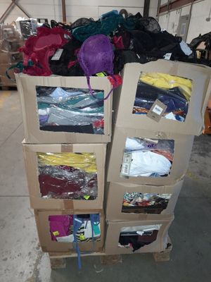 boxes of clothing are stacked on top of each other in a warehouse
