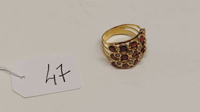 une bague en or sertie de grenats, avec une étiquette indiquant le prix
