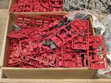 a box full of red legos sitting on the floor