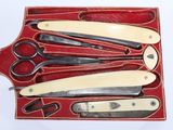 five pairs of scissors and a pair of scissors in a red case