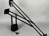 a black and white photo of a tripod with a light on it