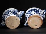 two blue and white vases sitting next to each other
