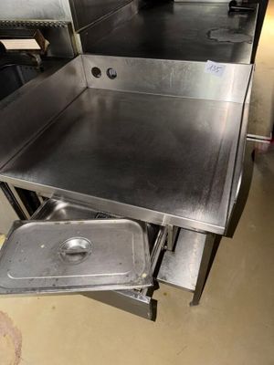 a stainless steel counter top with a metal pan in it