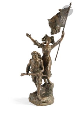 bronze statue of a woman holding a flag and a man holding a flag