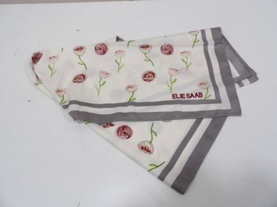 a white towel with a red flower on it