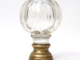 a clear glass ball on a brass base