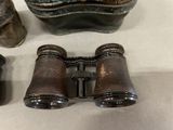 a pair of binoculars sitting on a table next to a purse