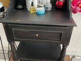 a black table with a lot of beauty products on it