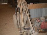a pile of tools sitting on the ground in a barn