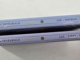 two books sitting on top of each other on a table