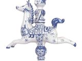 a blue and white figurine of a man riding a horse