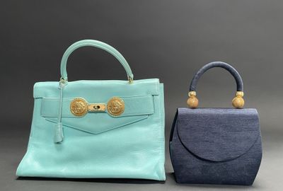 two small purses with handles and handles on a gray background