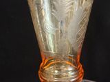 a glass vase sitting on top of a metal bowl