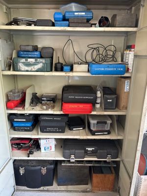 many different types of tools on the shelves in the closet