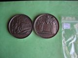 two coins sitting on a green surface next to a plastic bag