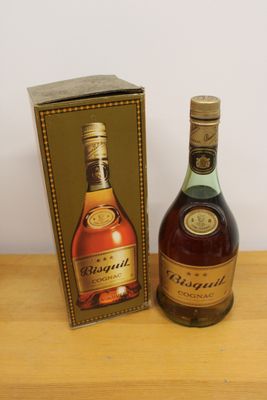 two bottles of brandy sitting next to each other on a wooden table