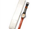 a watch that is sitting next to a plastic case