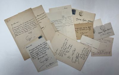 several old letters are piled on top of each other on a table