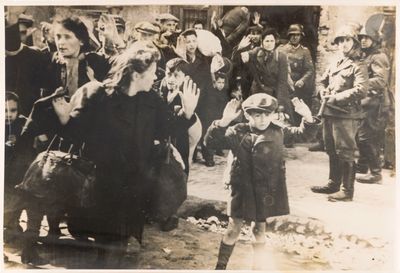 a black and white photo of a little girl standing in front of a crowd of people